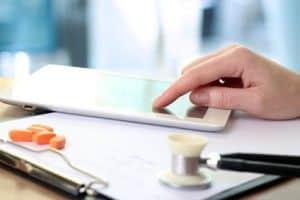 Doctor  working with tablet computer. orange pills,  prescriptio