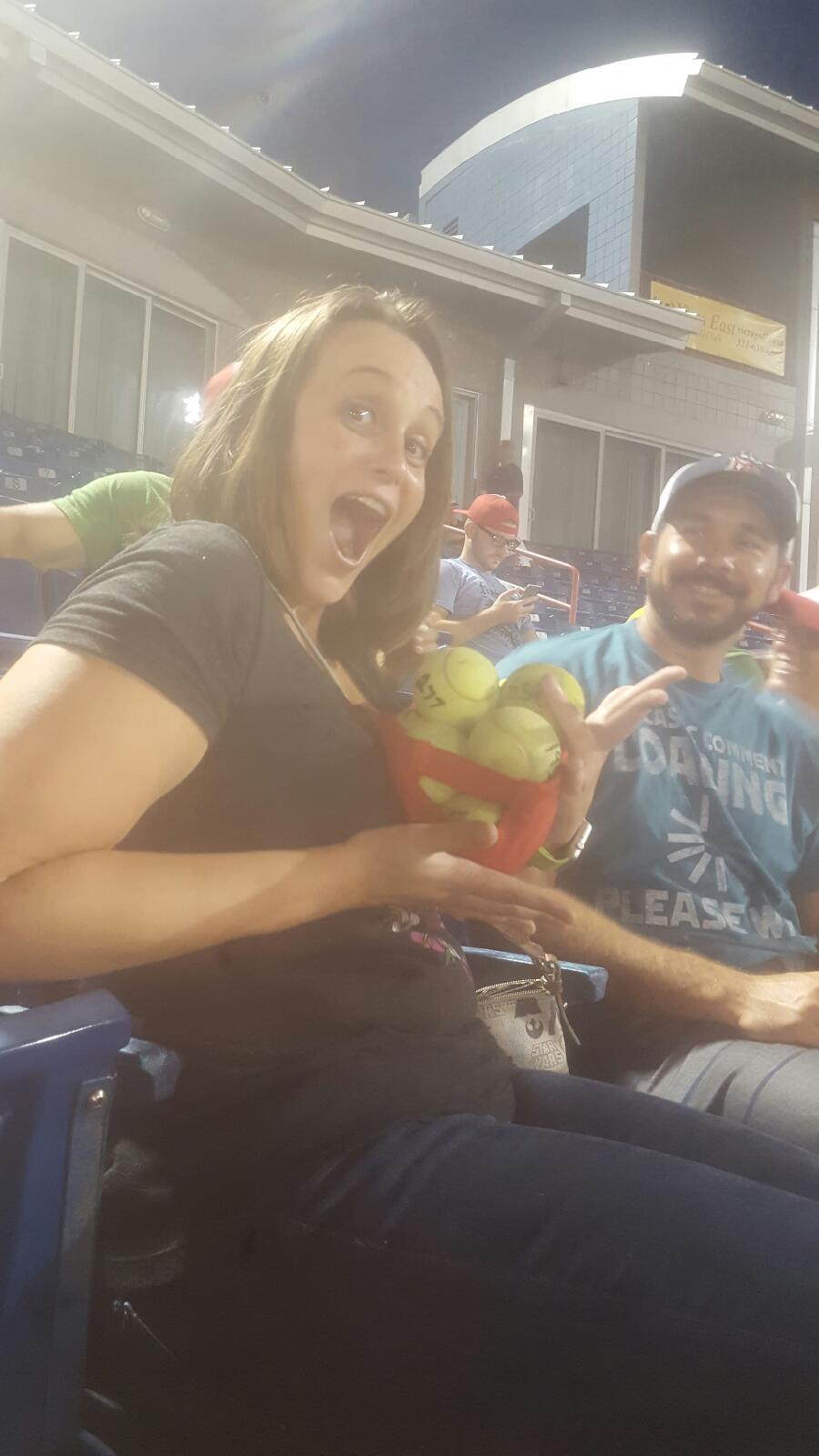 Jessica Slaughter holding a lot of baseballs